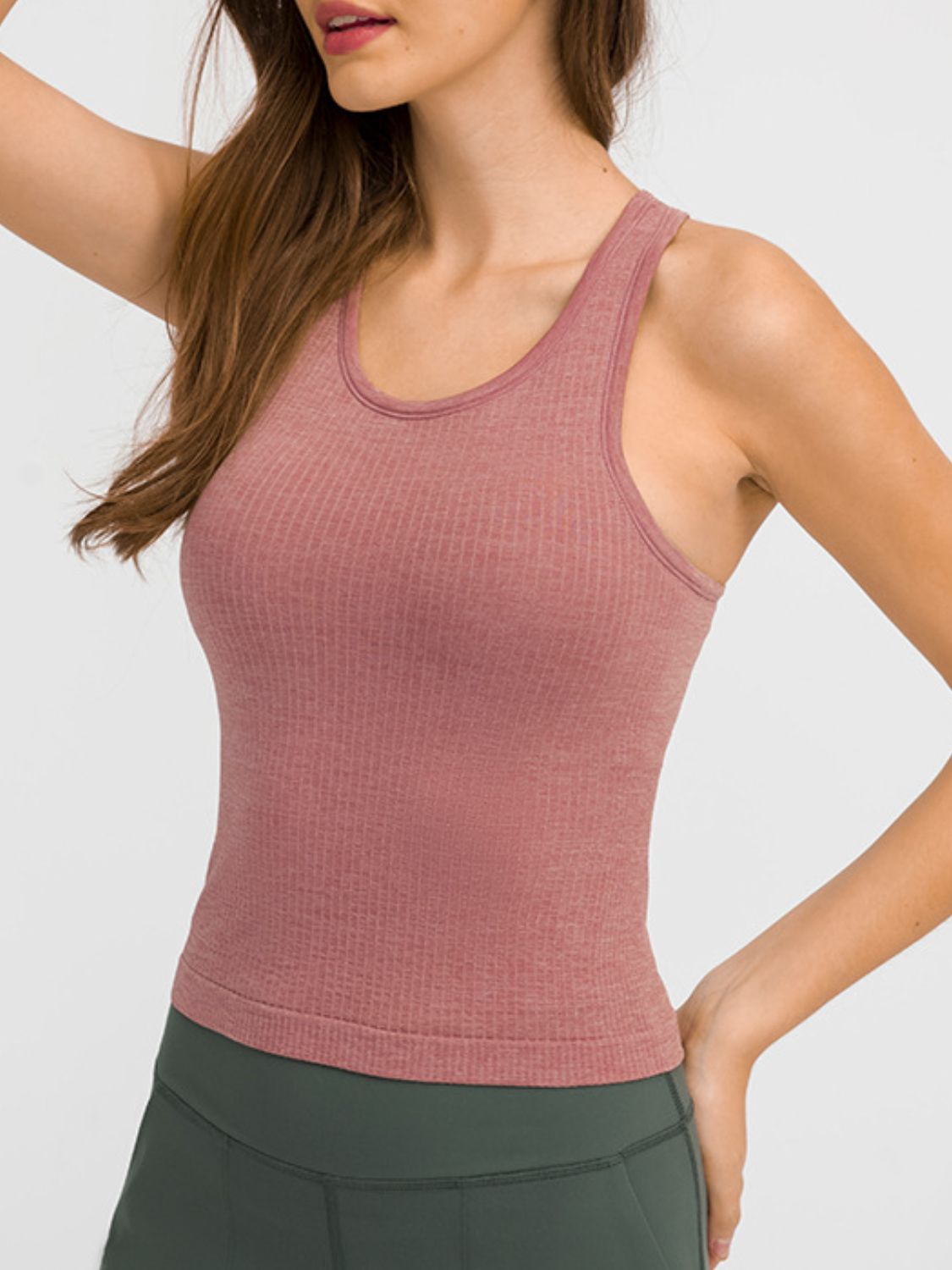Round neck racerback active tank with removable padding.