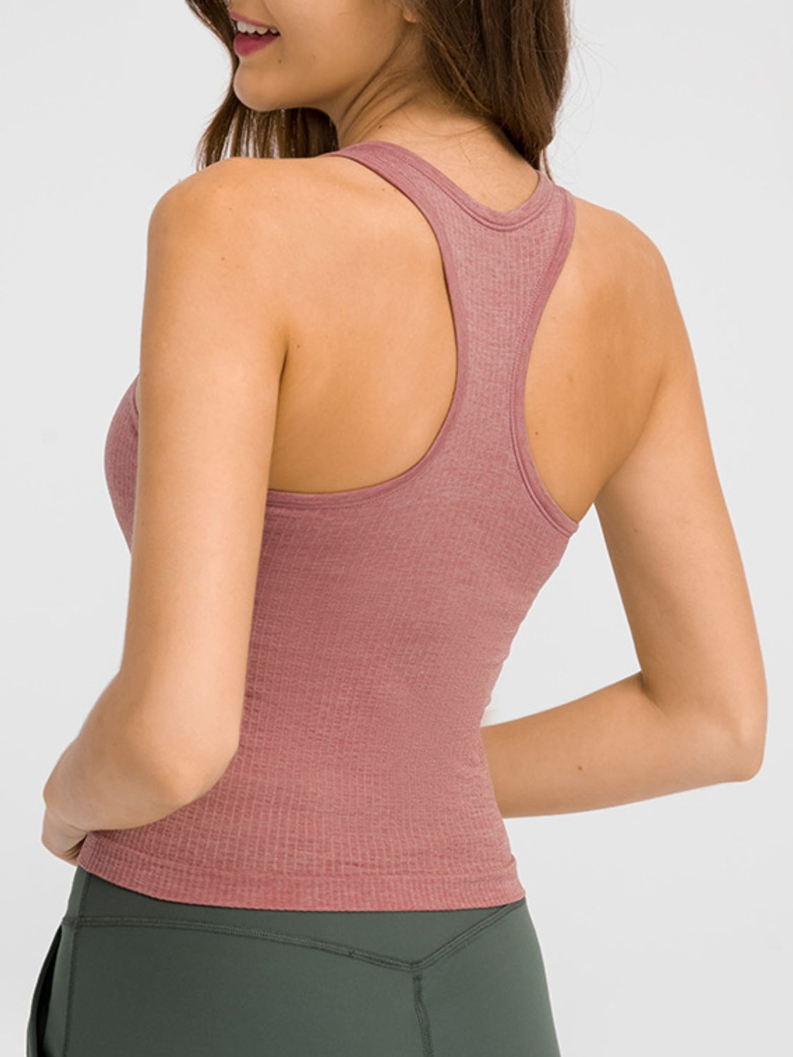 Round neck racerback active tank with removable padding.