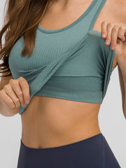 Round neck racerback active tank with removable padding.