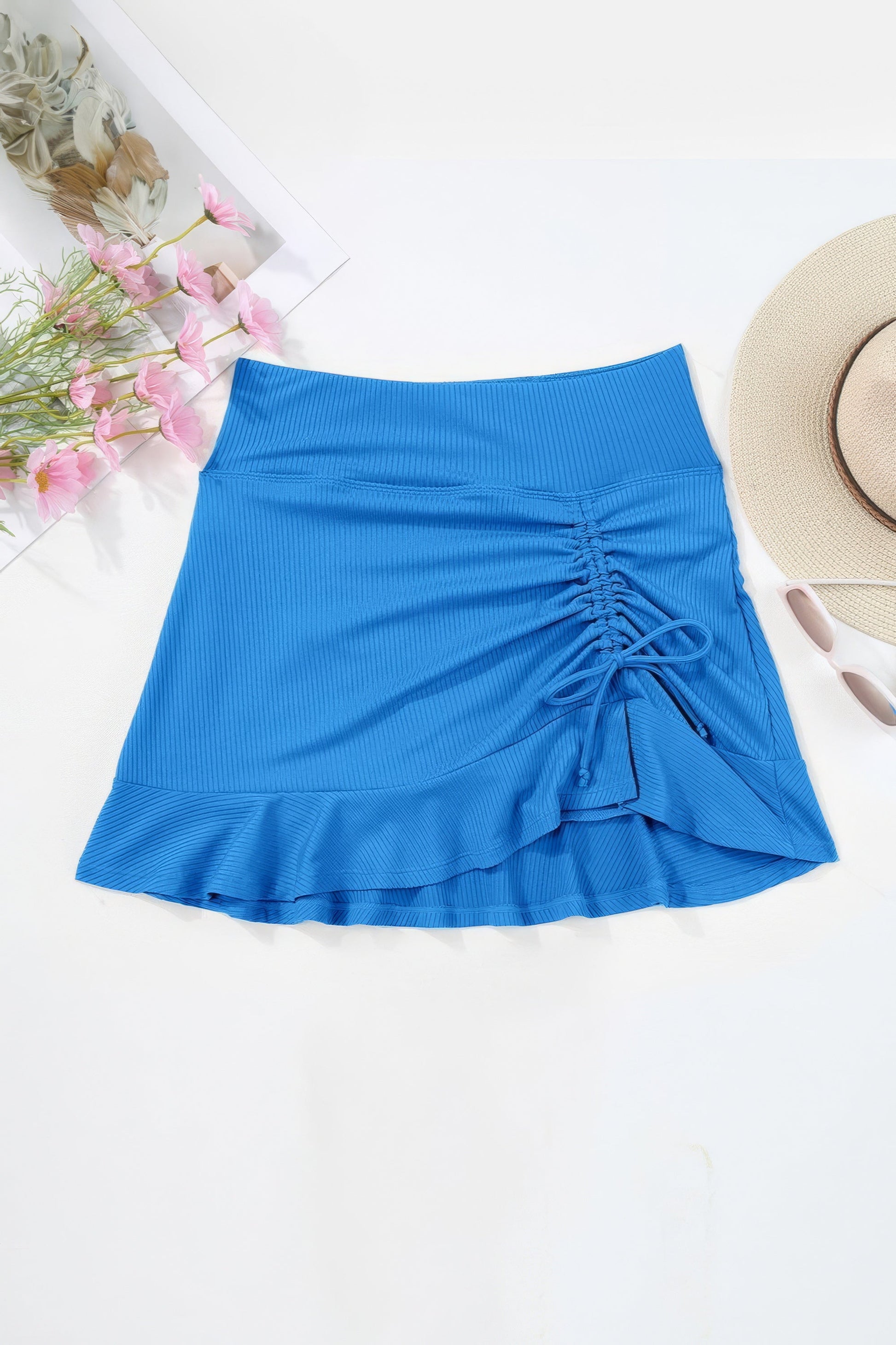 Ruched Swim Skirt. Sky Blue ruffled swim skirt with elastic waist and drawstring. Women's swimwear bottoms.