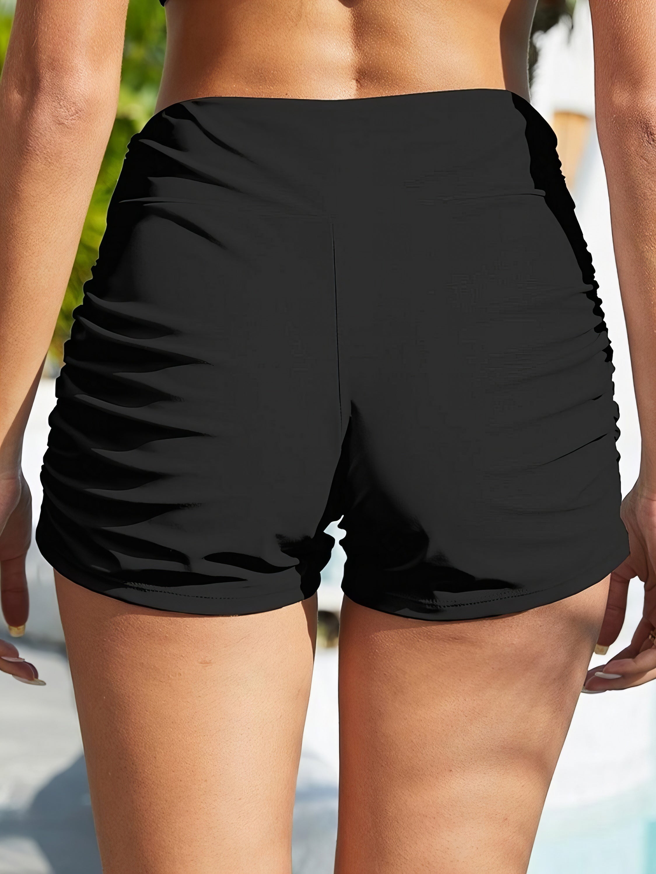 Ruched Mid-Rise Swim Shorts. Women's comfortable, stylish black swim shorts. Perfect for swimming and beach days.