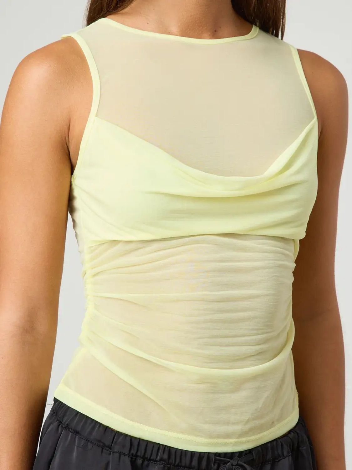 Ruched round neck tank top with semi-sheer design.