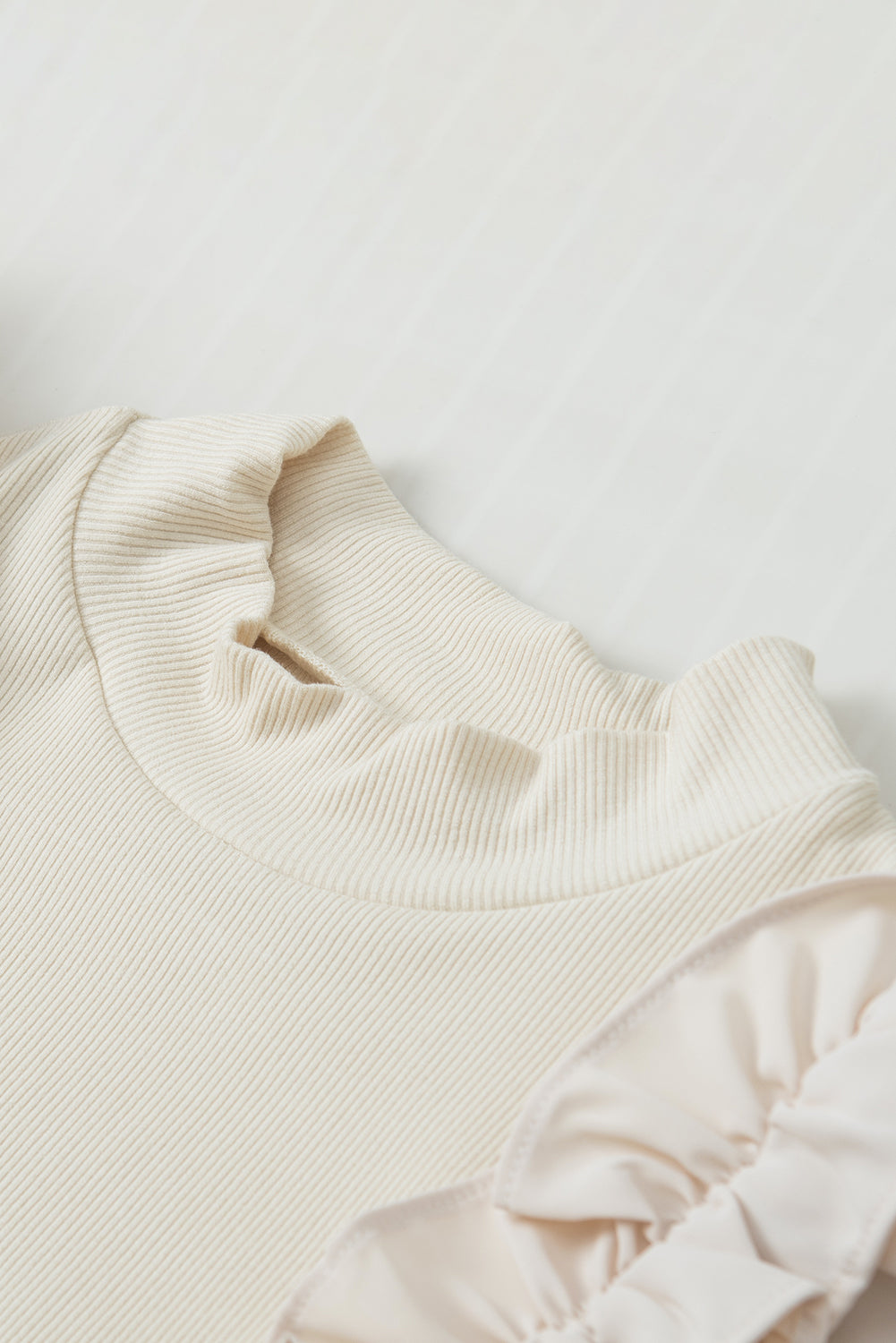 Ruffle Flutter Sleeve Mock Neck Ribbed Top.
