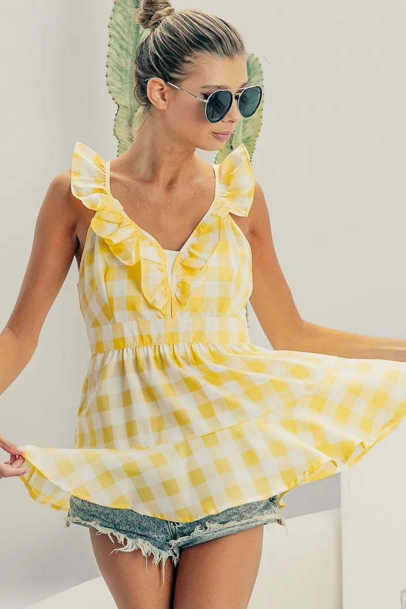Ruffled neckline sleeveless check plaid peplum top.