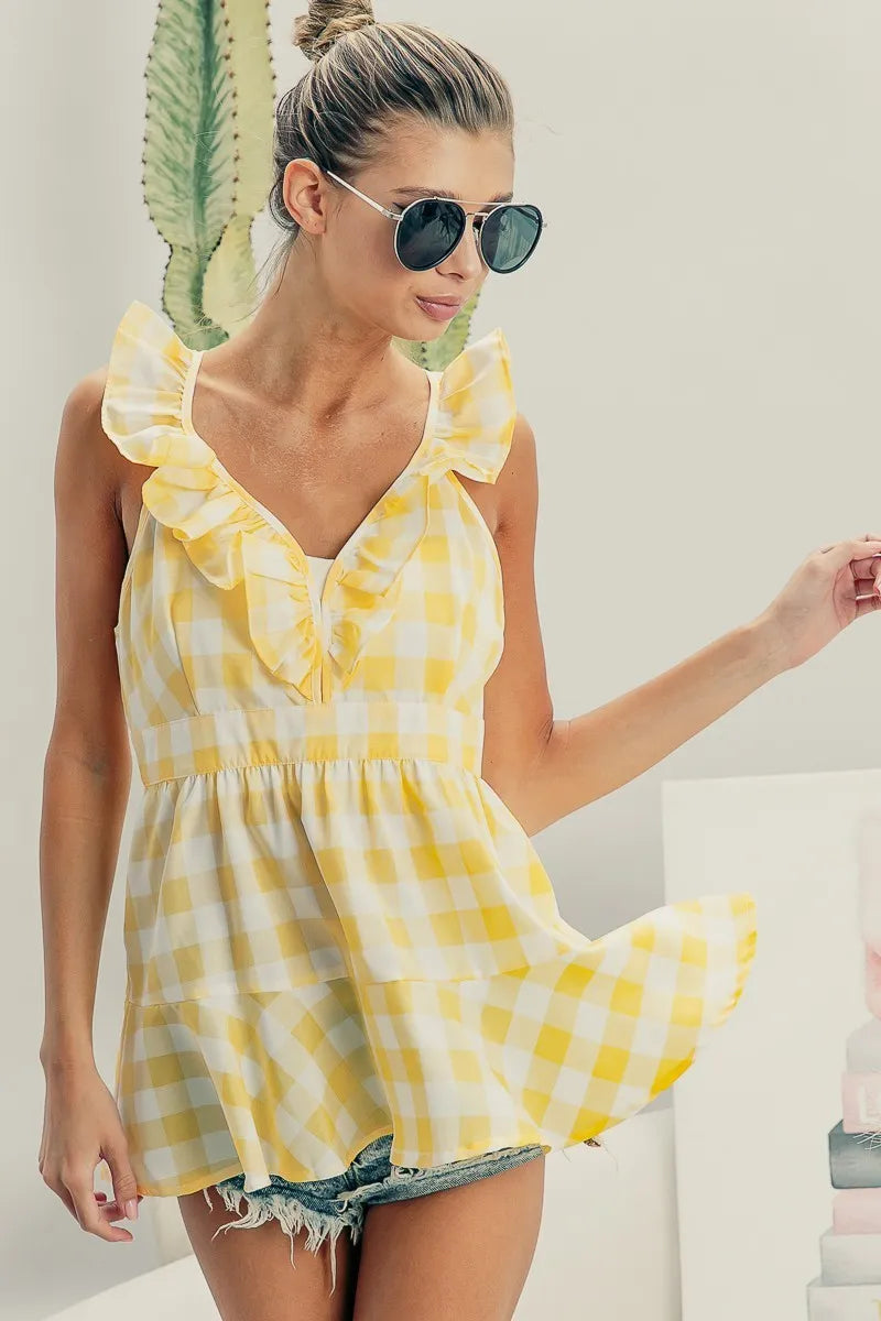 Ruffled neckline sleeveless check plaid peplum top.