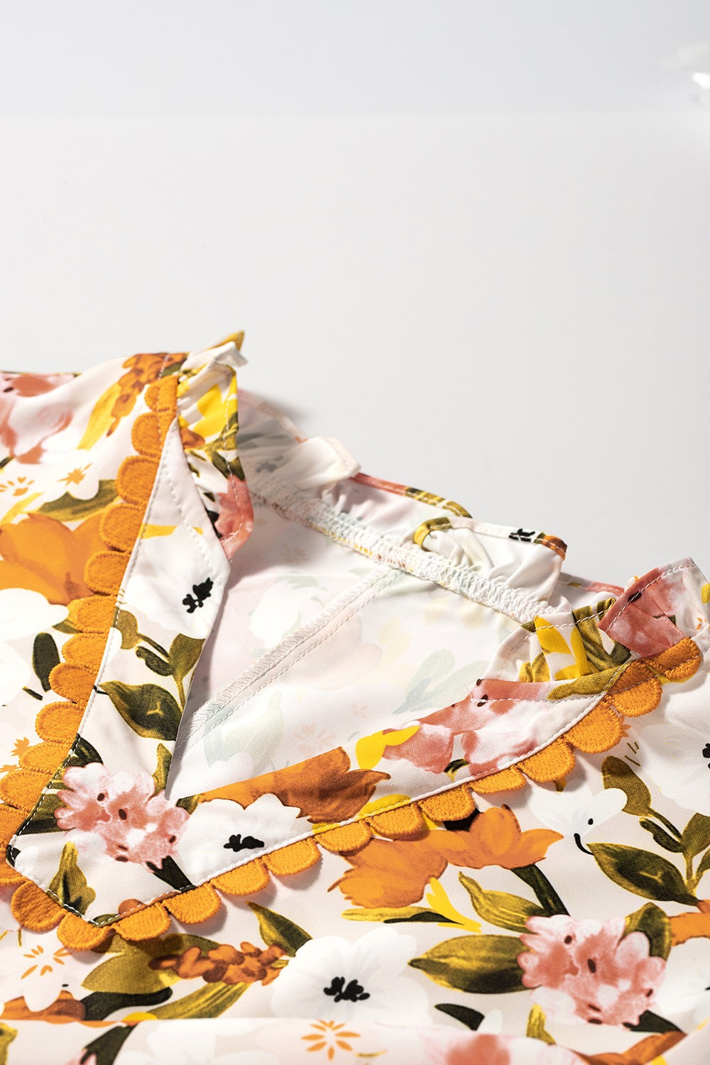Ruffled Notched Short Sleeve Floral Blouse.
