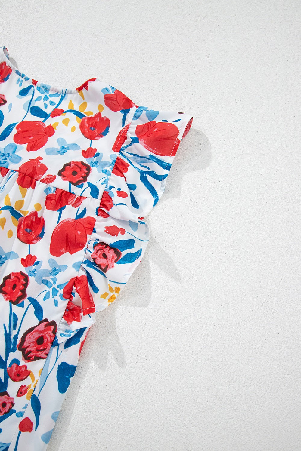 Ruffled Printed V-Neck Cap Sleeve Blouse.