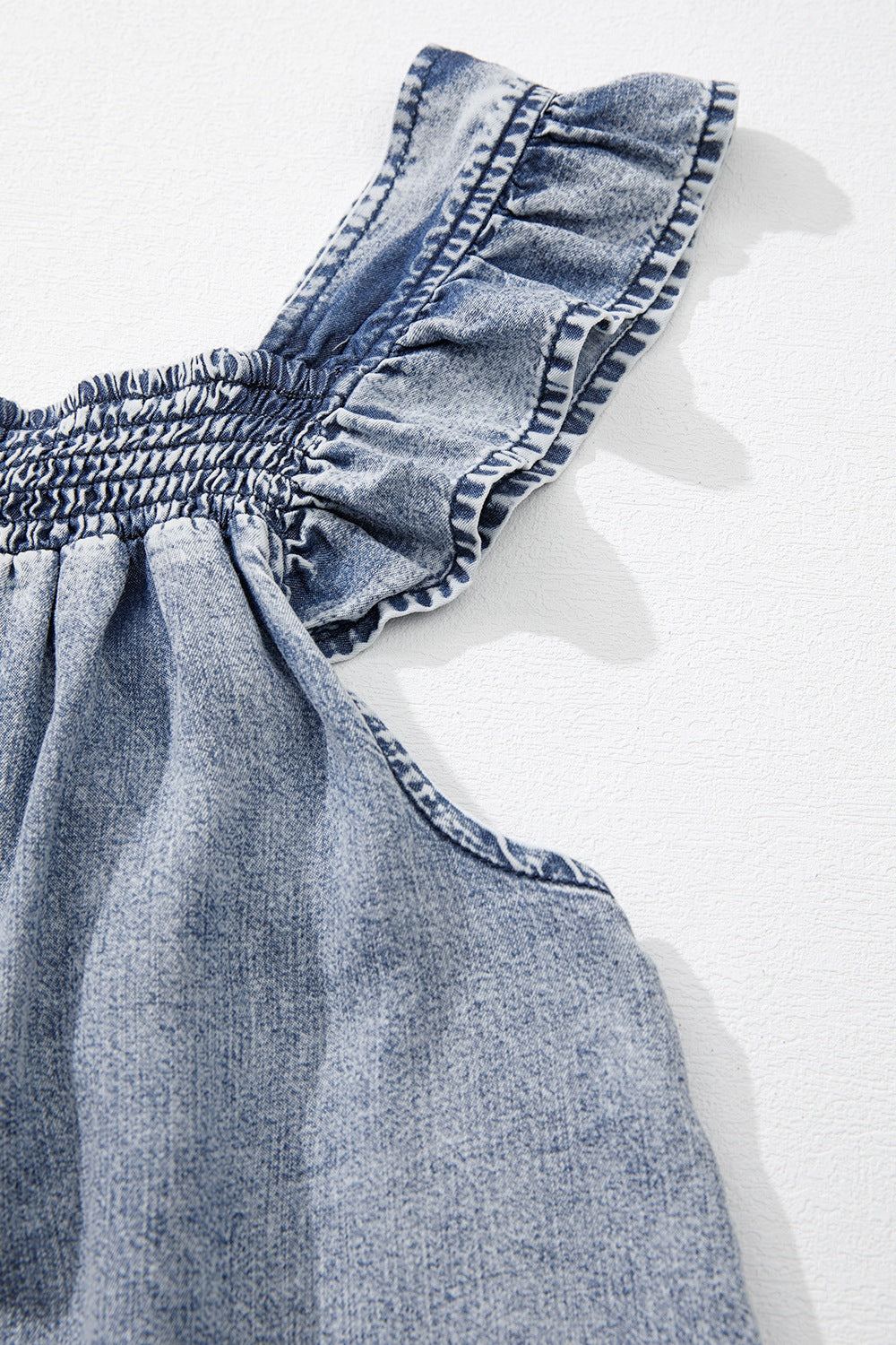 Ruffled shirred denim top.