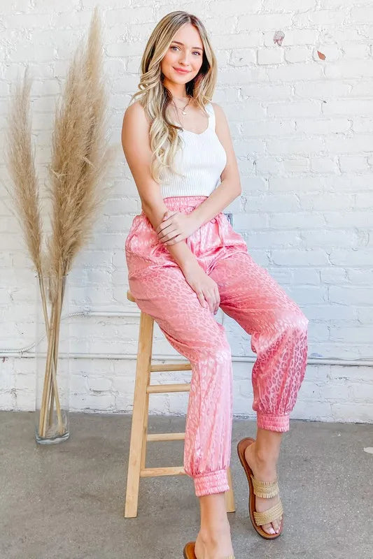 Satin leopard print joggers with drawstring and pockets.
