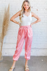 Satin leopard print joggers with drawstring and pockets.