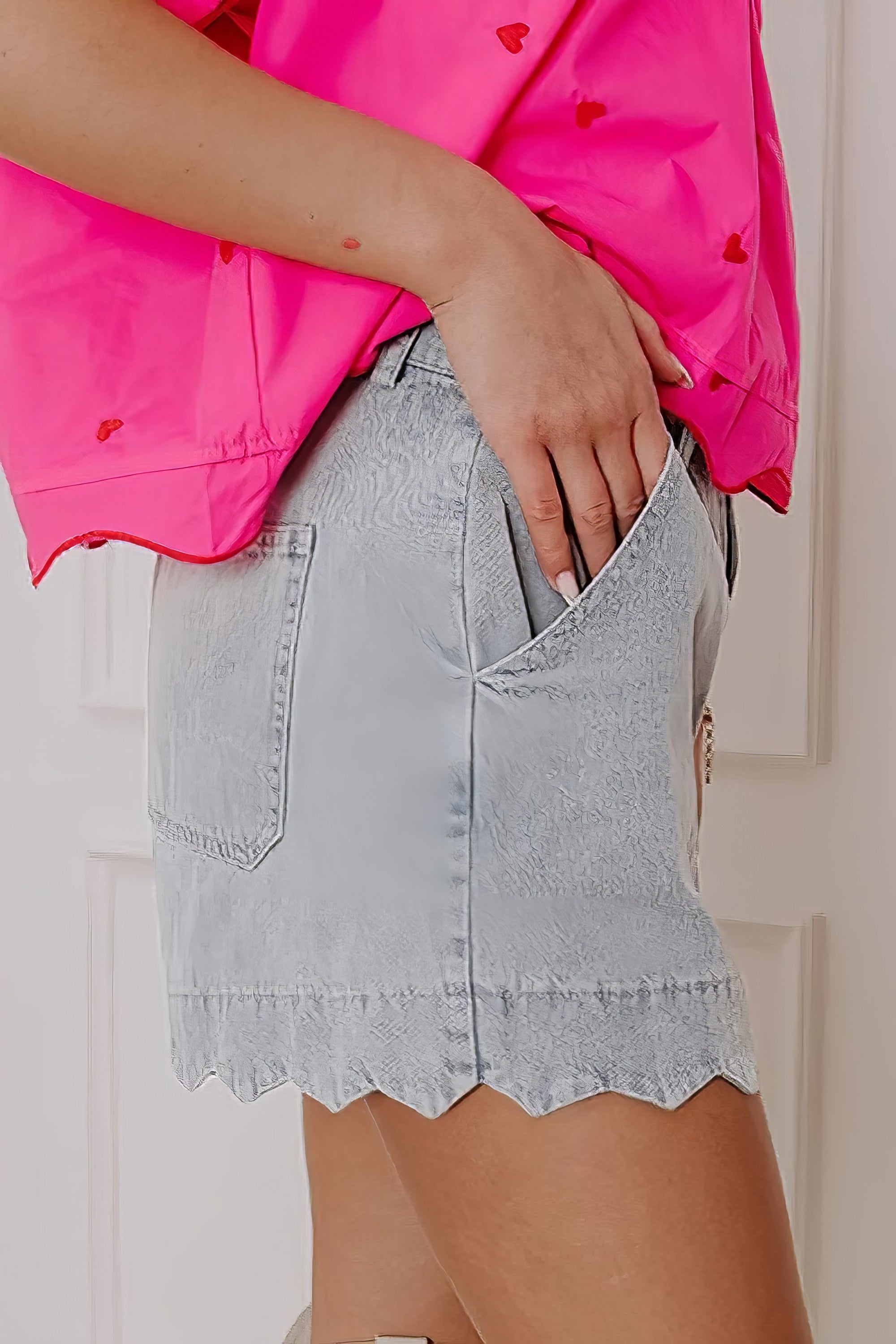 Scalloped hem denim shorts.