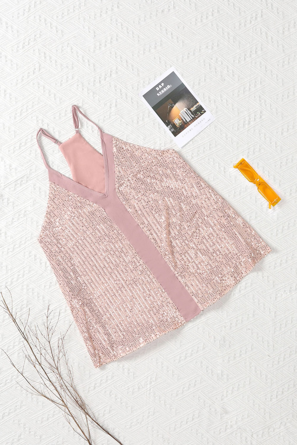 Sequin racerback tank with adjustable elastic strap.