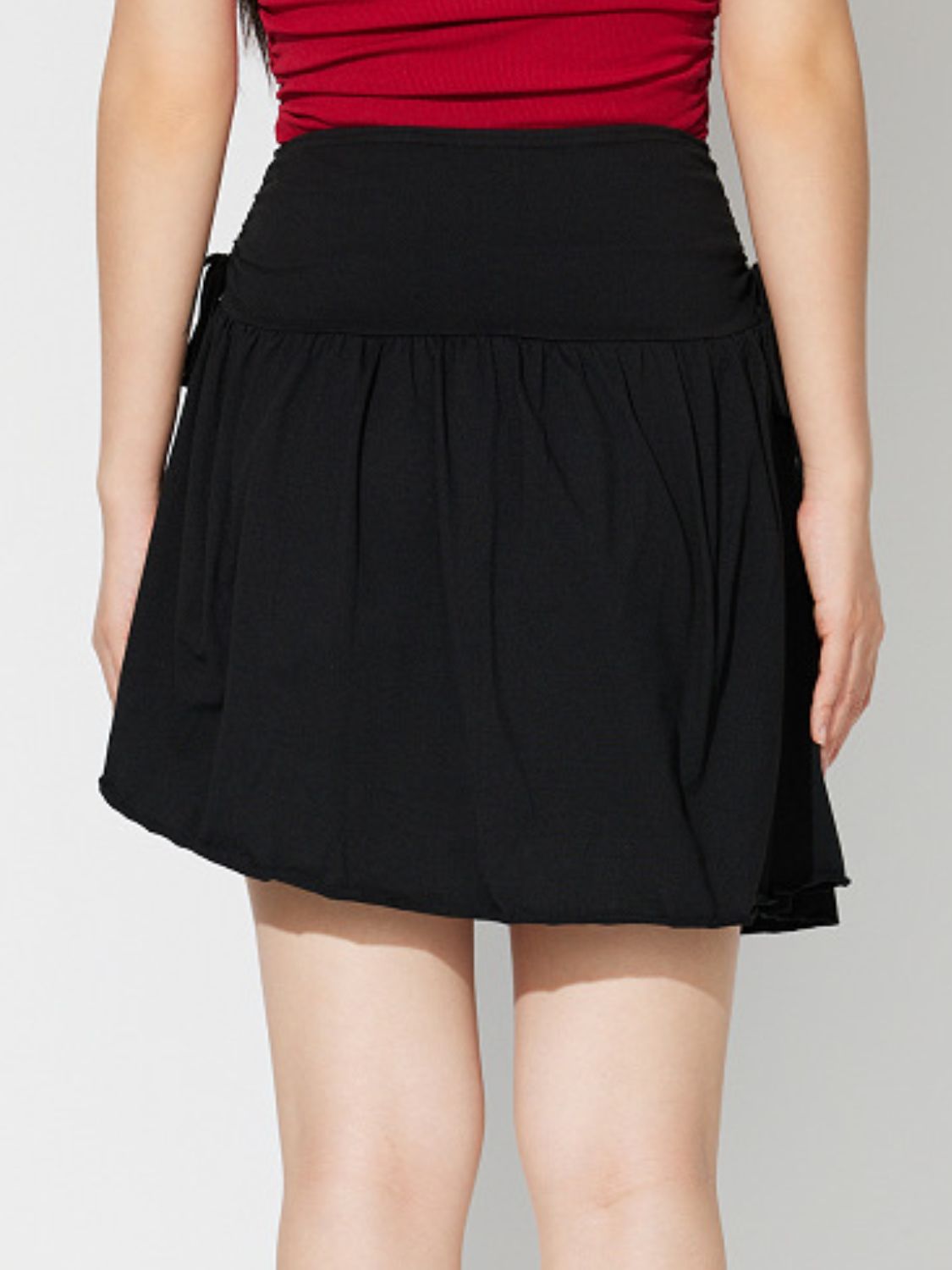 Side Tie Asymmetric Hem Mini Skirt.