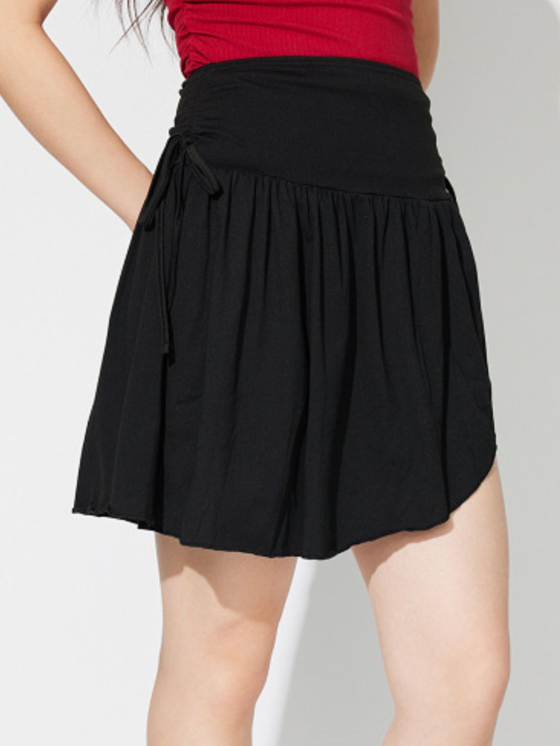 Side Tie Asymmetric Hem Mini Skirt.