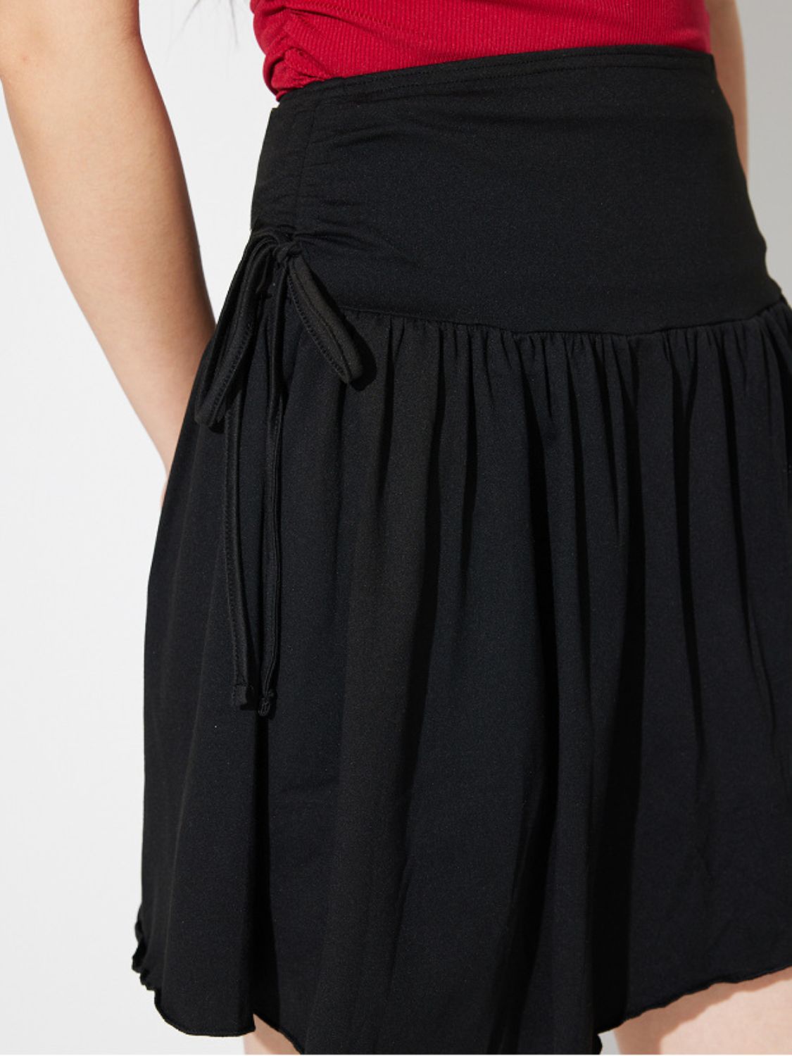 Side Tie Asymmetric Hem Mini Skirt.