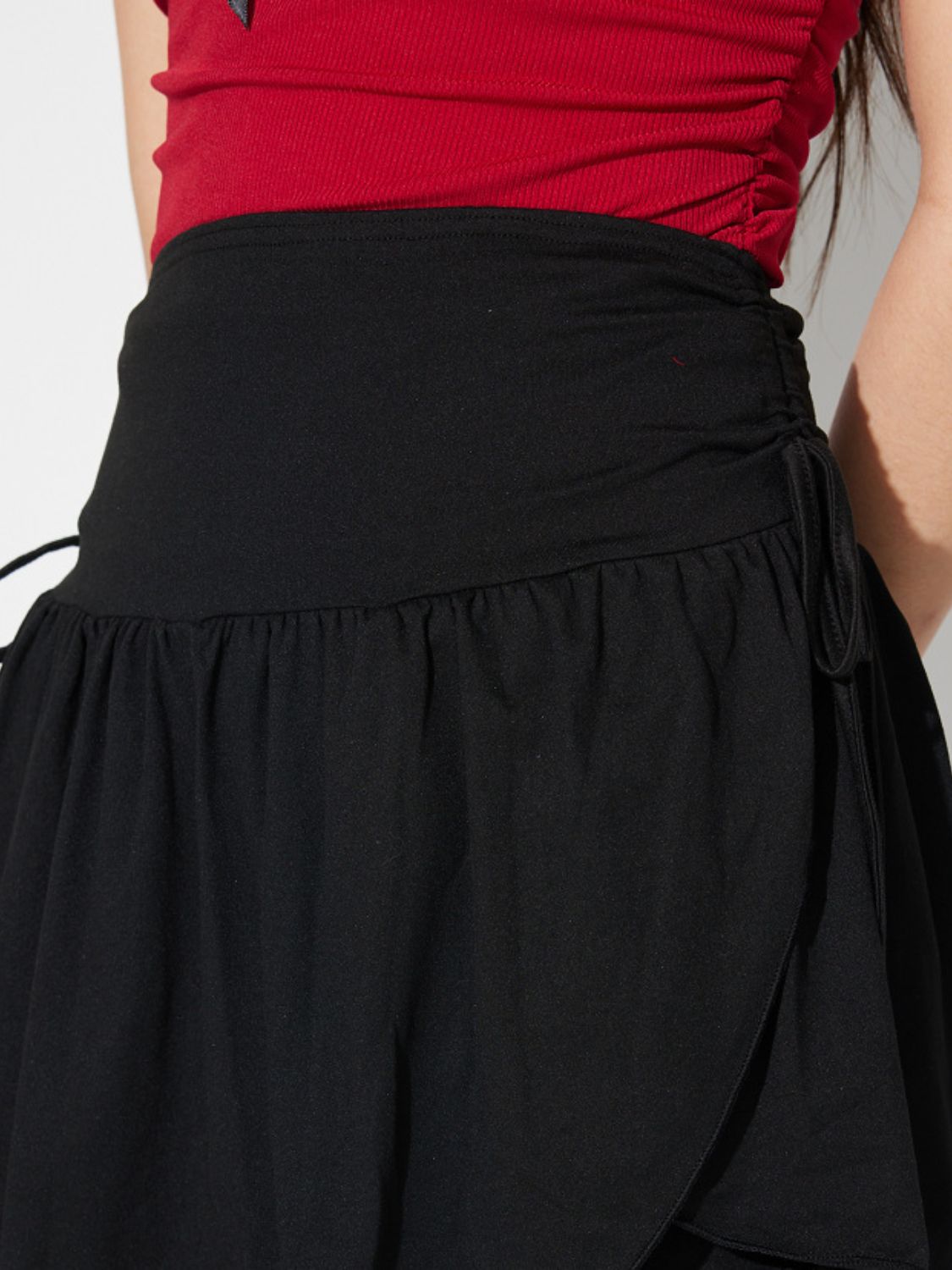 Side Tie Asymmetric Hem Mini Skirt.