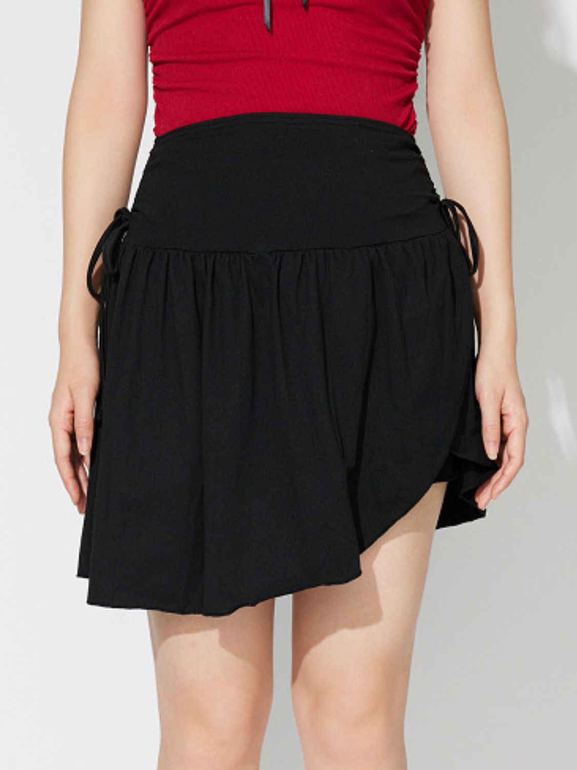 Side Tie Asymmetric Hem Mini Skirt.