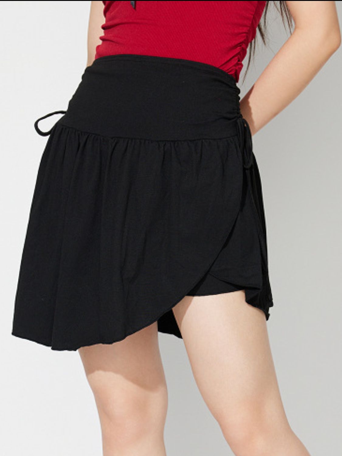 Side Tie Asymmetric Hem Mini Skirt.