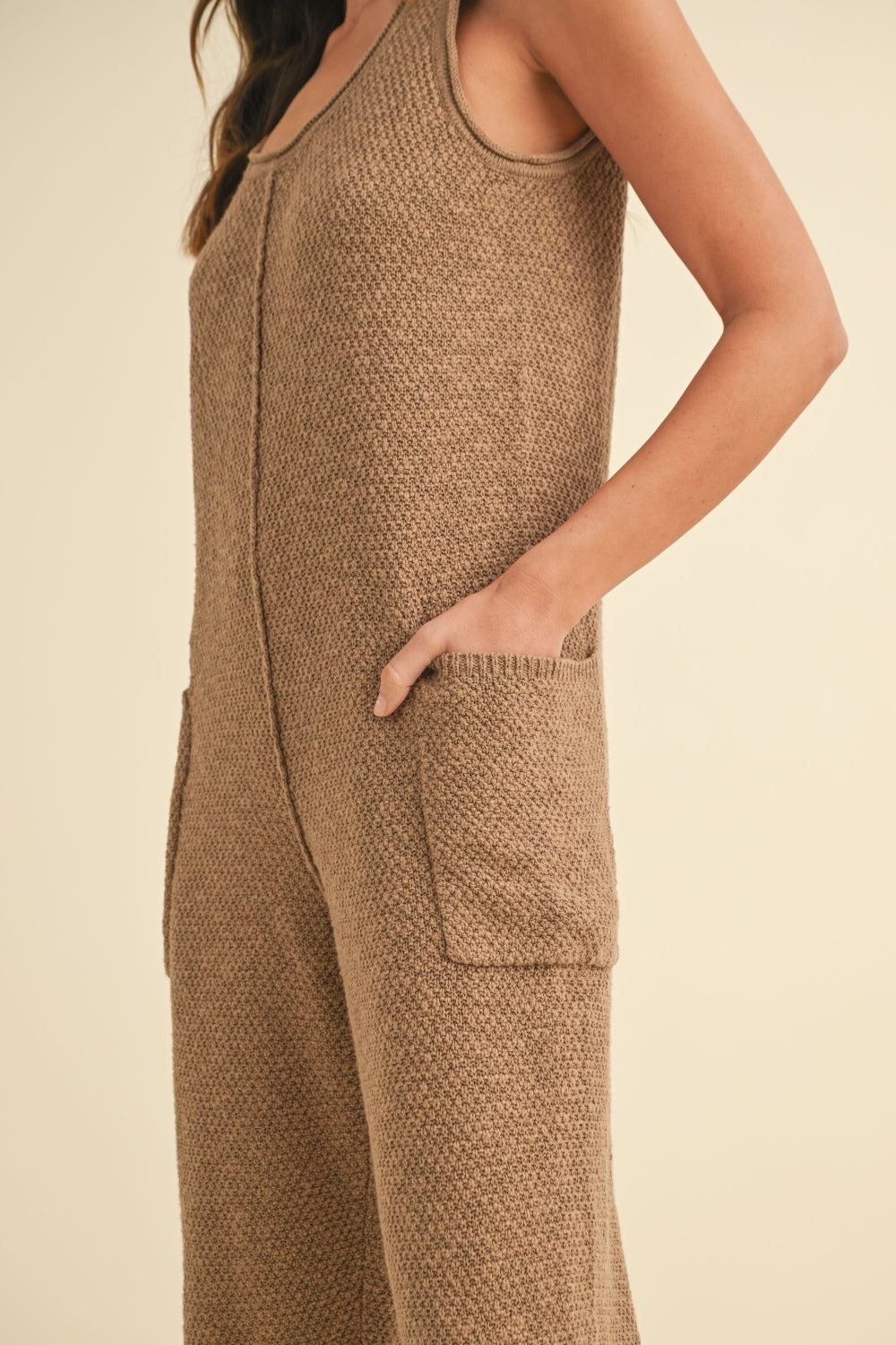 Sleeveless Knit Crop Jumpsuit with Pockets and Exposed Seam.