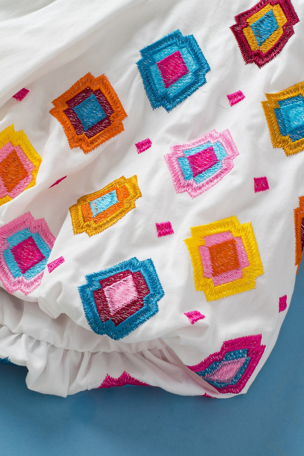 Smocked Neck Embroidered Puff Sleeve Top.