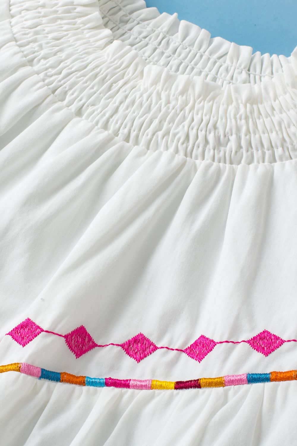 Smocked Neck Embroidered Puff Sleeve Top.