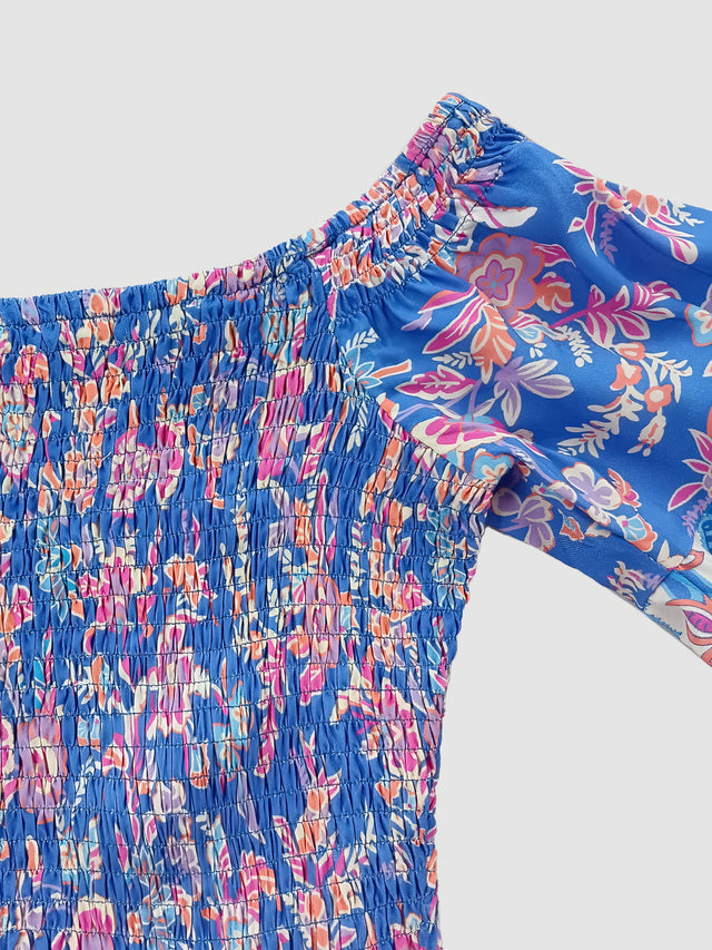 Blue floral patterned pants on a light gray background