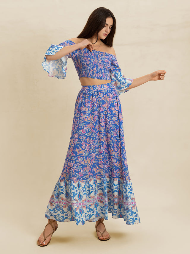 Woman wearing a blue floral dress on a beige background