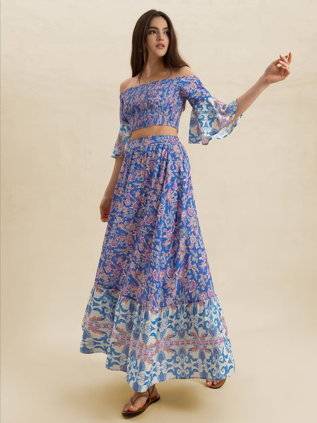 Woman wearing a blue floral dress on a beige background