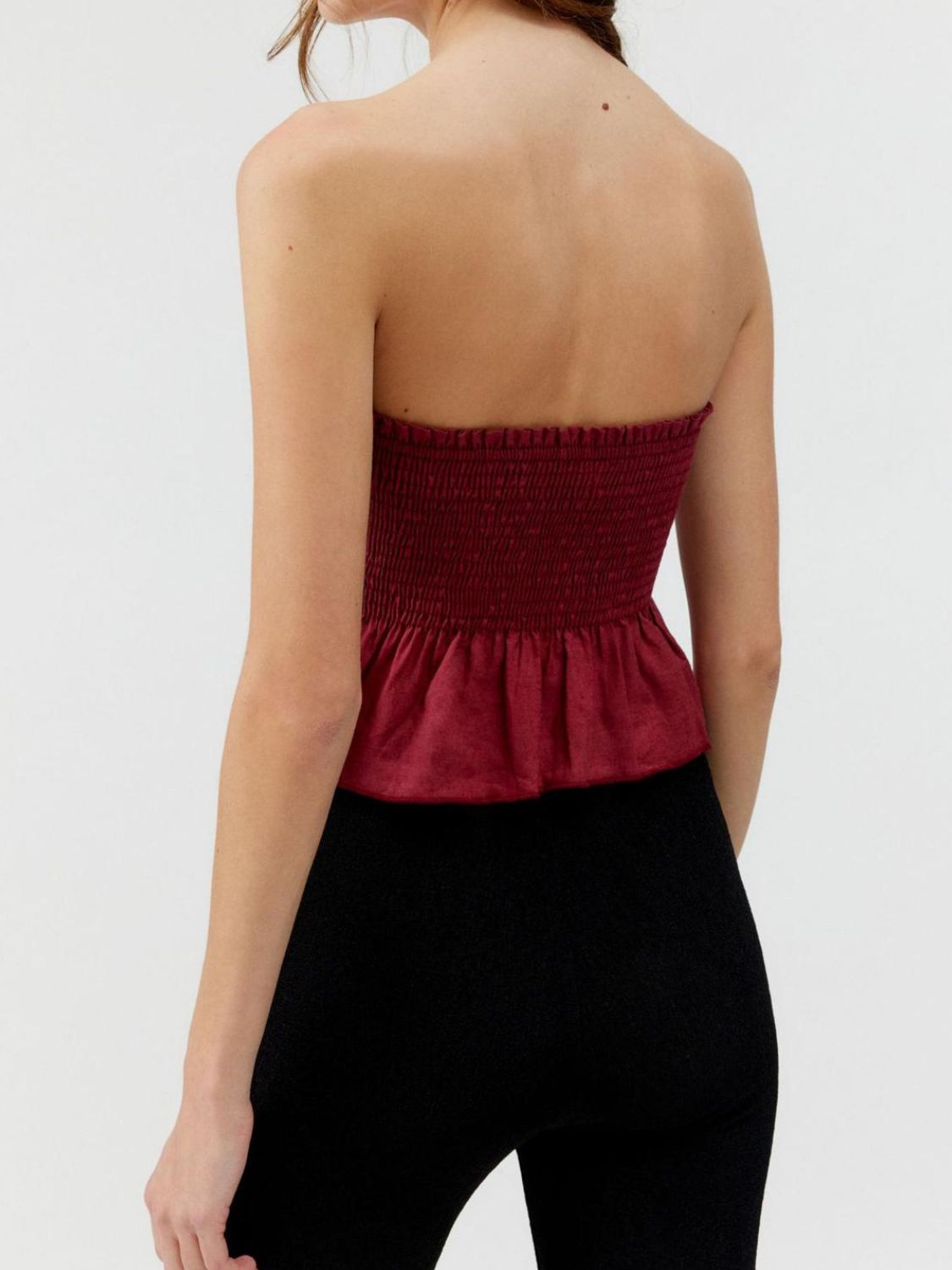 Smocked peplum tube top with ruched and ruffled details, slightly stretchy.