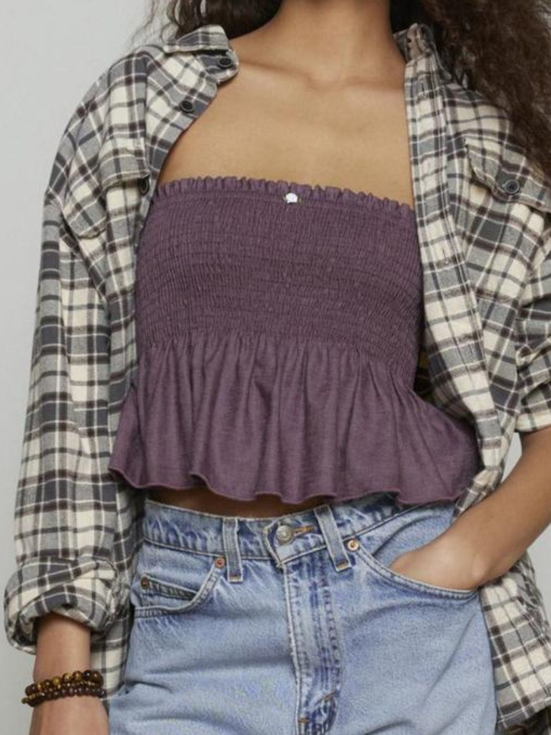 Smocked peplum tube top with ruched and ruffled details, slightly stretchy.
