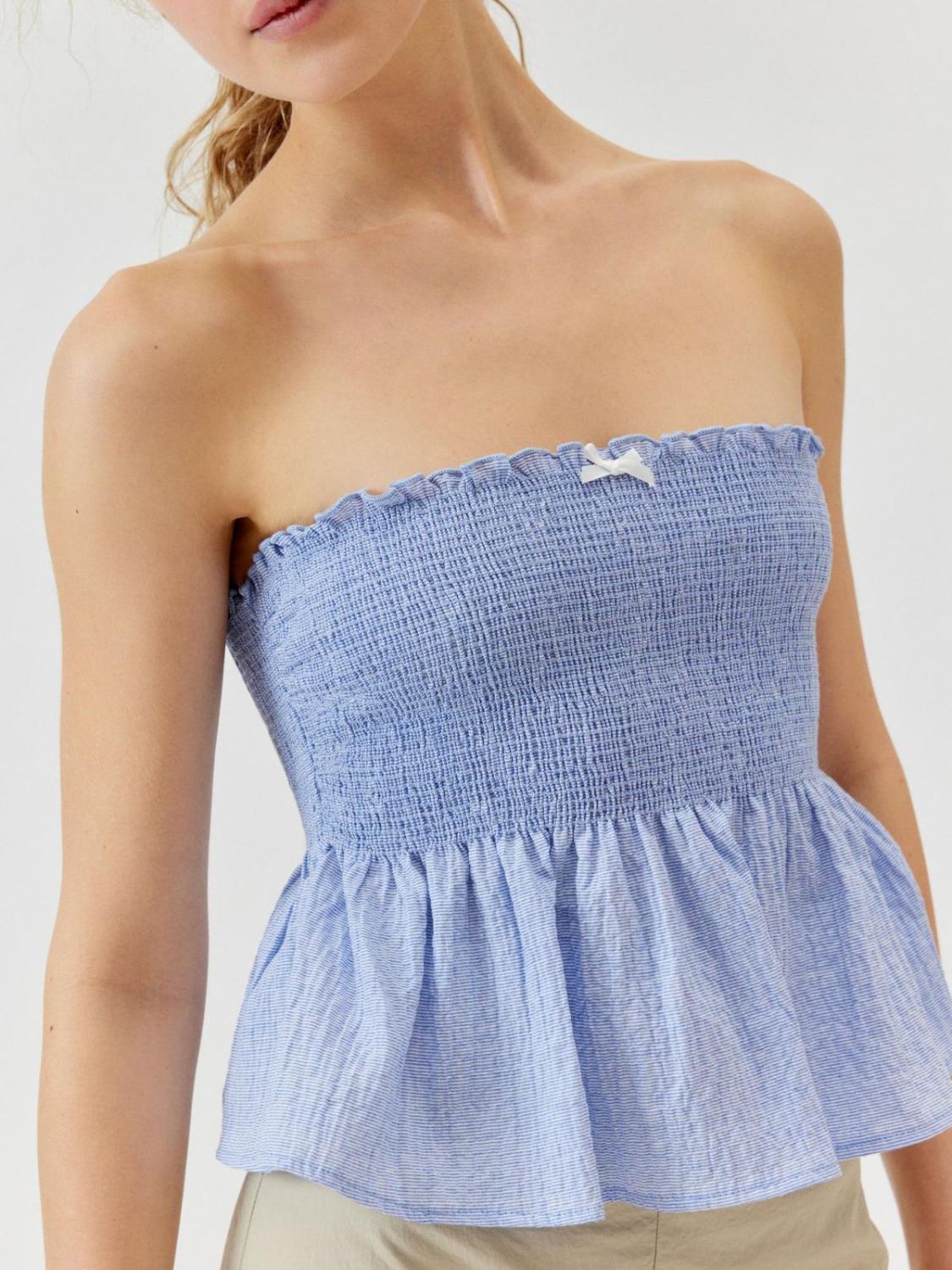 Smocked peplum tube top with ruched and ruffled details, slightly stretchy.