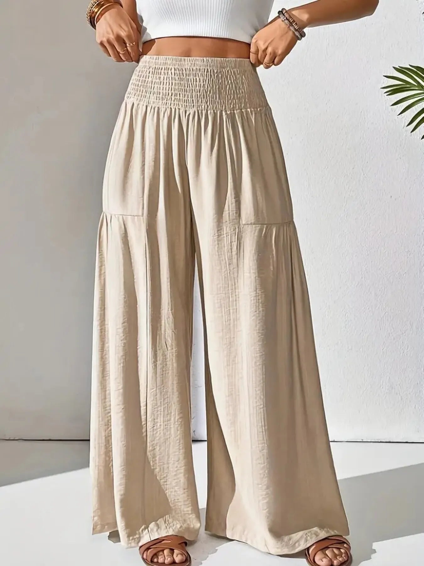 Smocked waist wide leg pants with pockets.