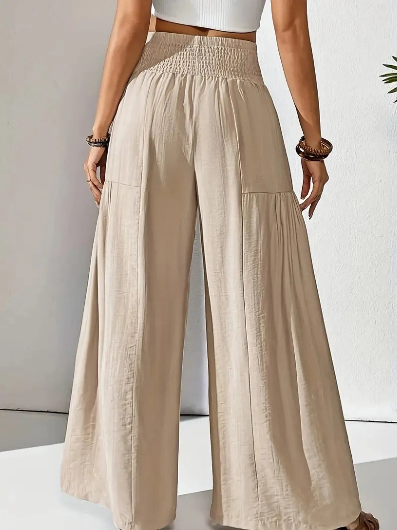 Smocked waist wide leg pants with pockets.