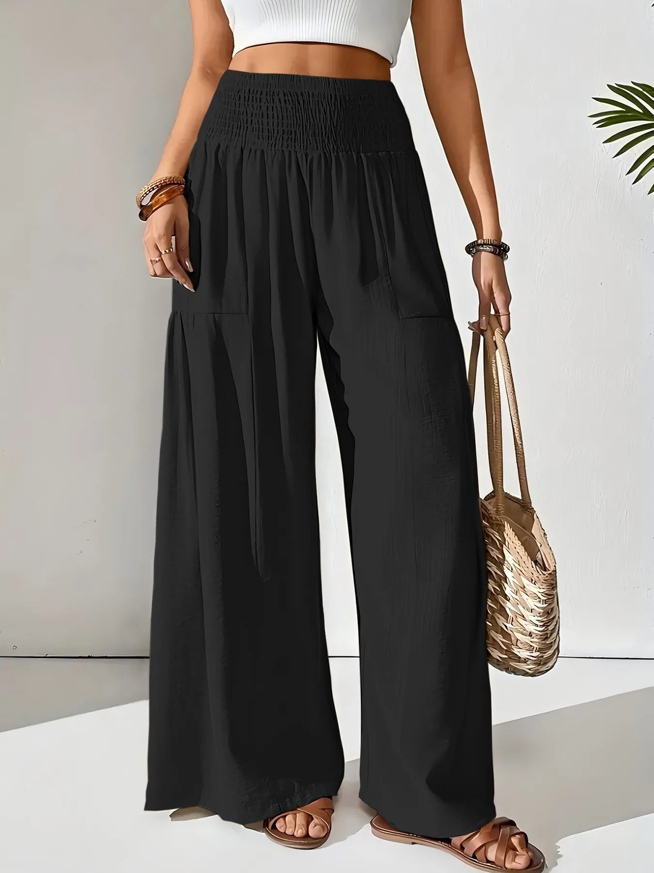 Smocked waist wide leg pants with pockets.