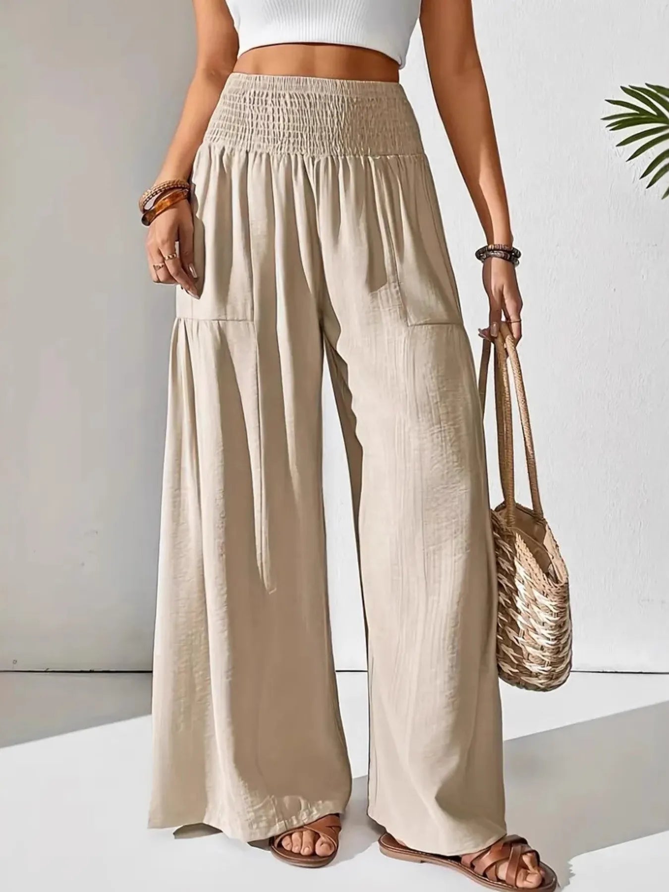 Smocked waist wide leg pants with pockets.