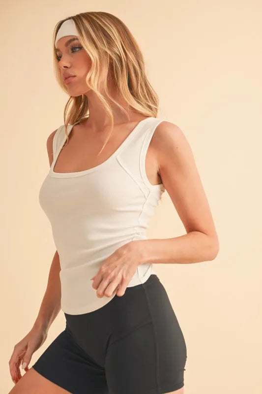 Square neck wide strap tank with ribbed texture, moderately stretchy.