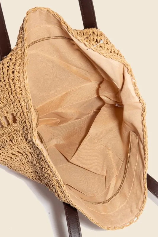 Medium straw braided rounded tote bag.