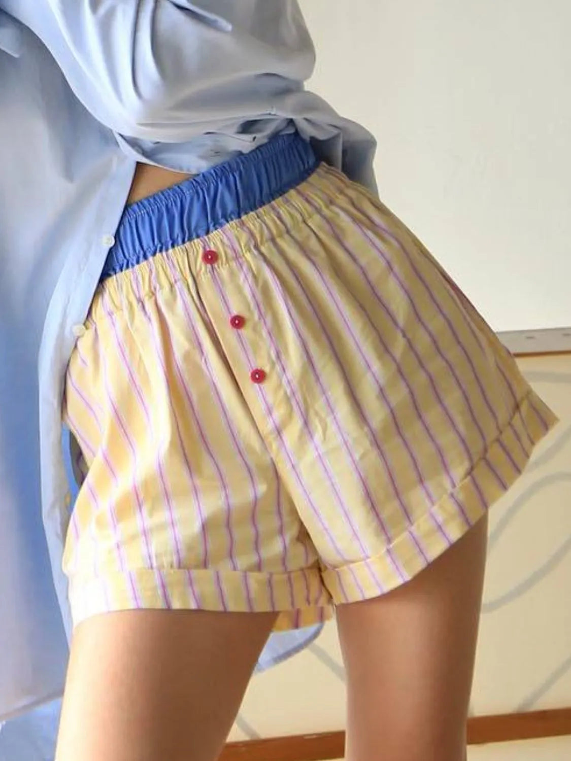 High-waist denim shorts with buttons and pockets.