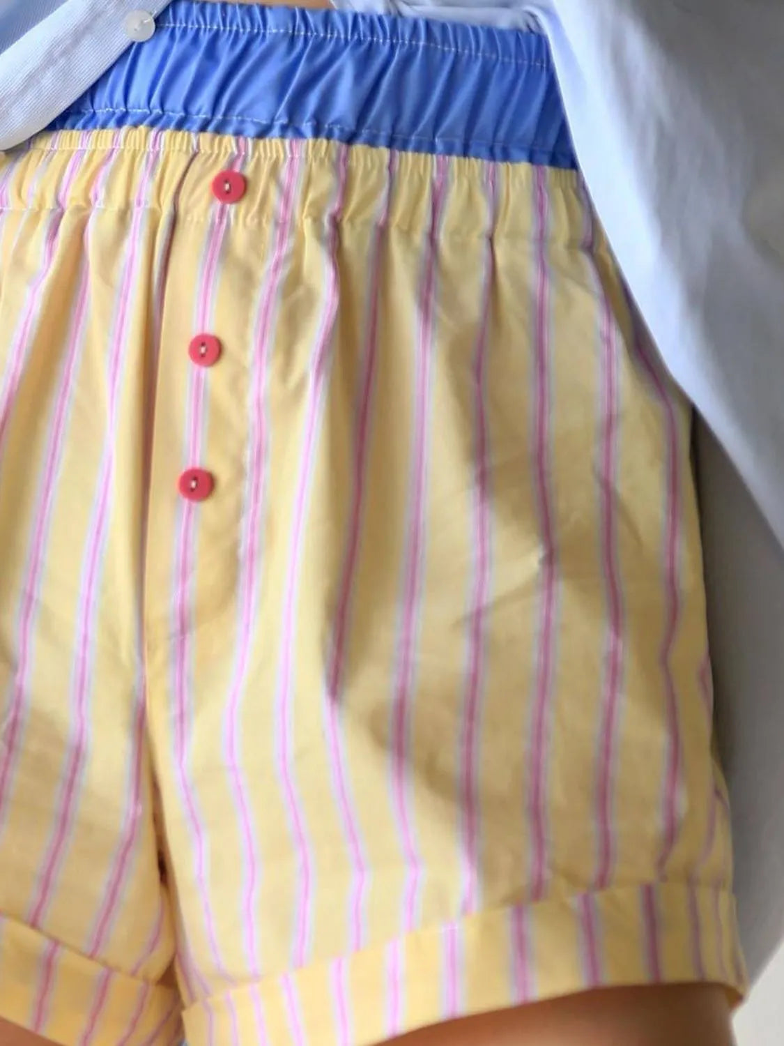 High-waist denim shorts with buttons and pockets.