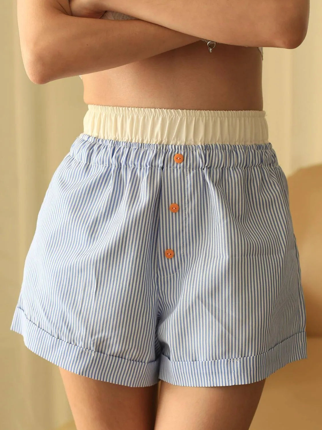 High-waist denim shorts with buttons and pockets.