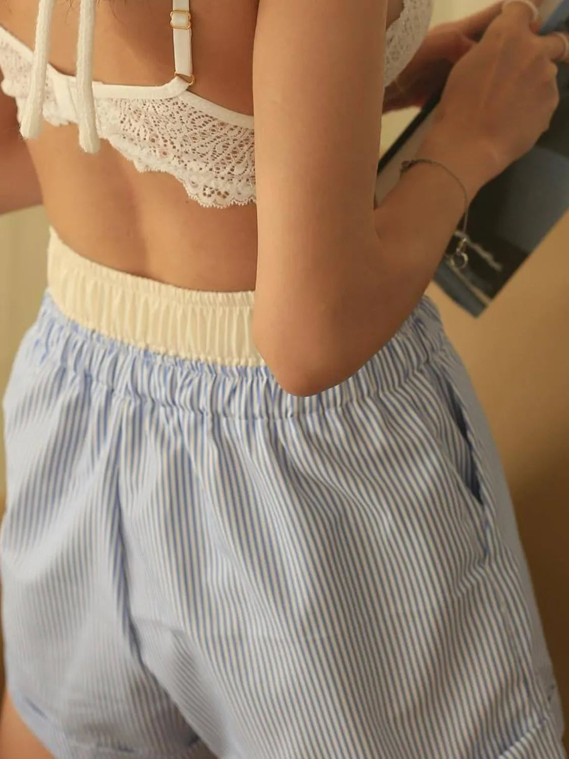 High-waist denim shorts with buttons and pockets.