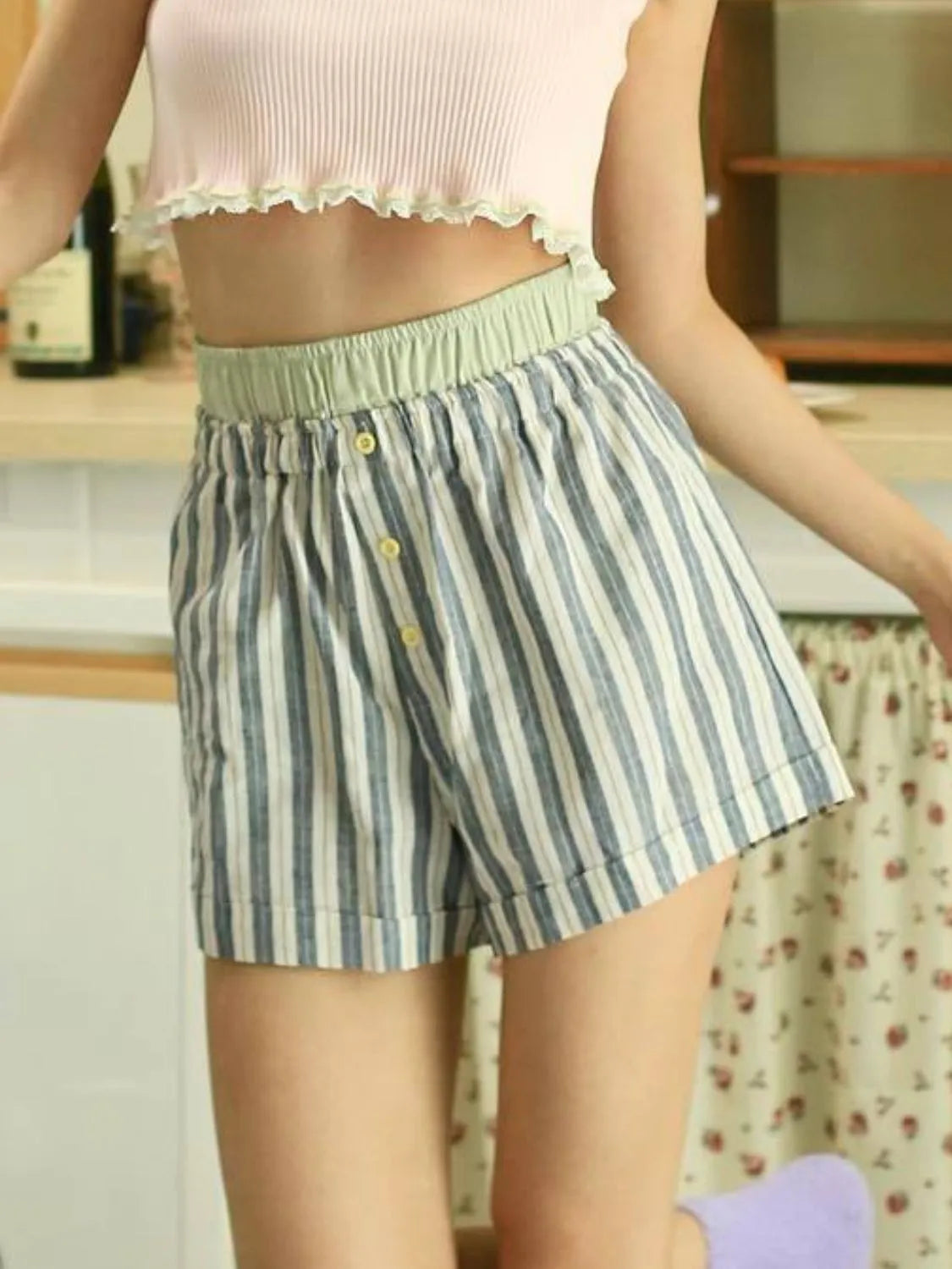 High-waist denim shorts with buttons and pockets.