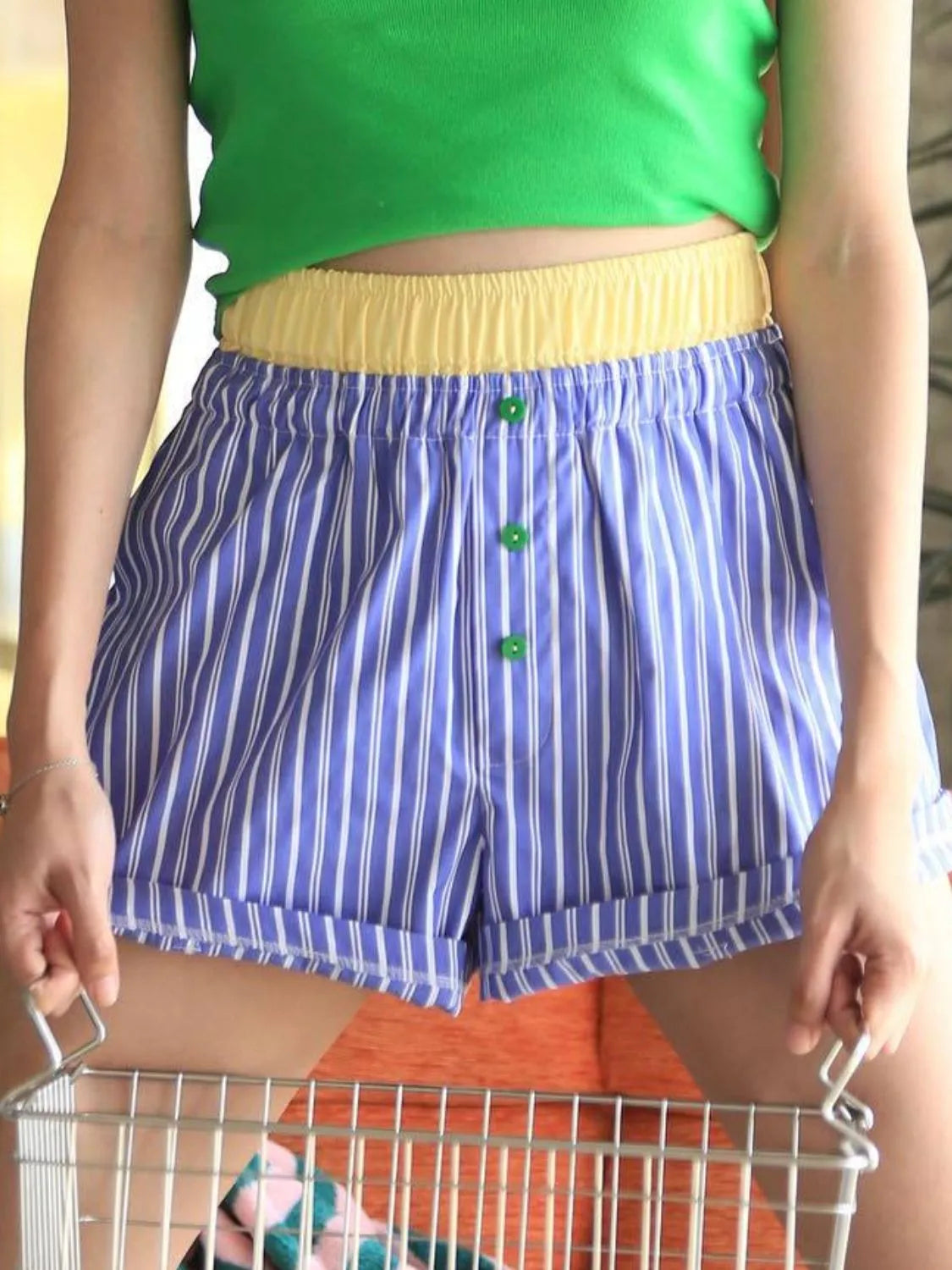 High-waist denim shorts with buttons and pockets.