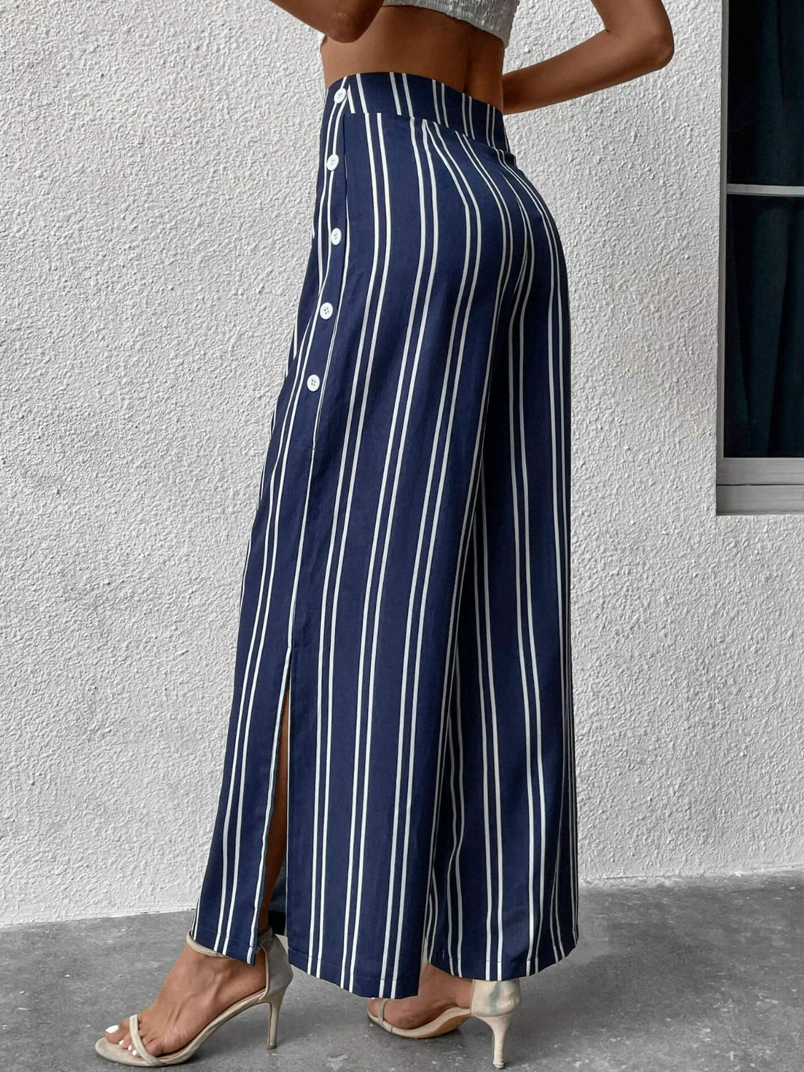 Striped slit wide leg pants with decorative buttons, casual minimalist style.