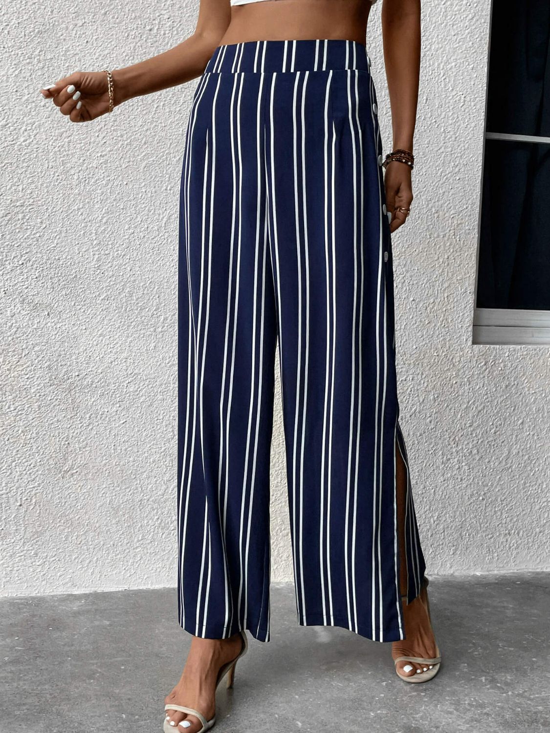 Striped slit wide leg pants with decorative buttons, casual minimalist style.