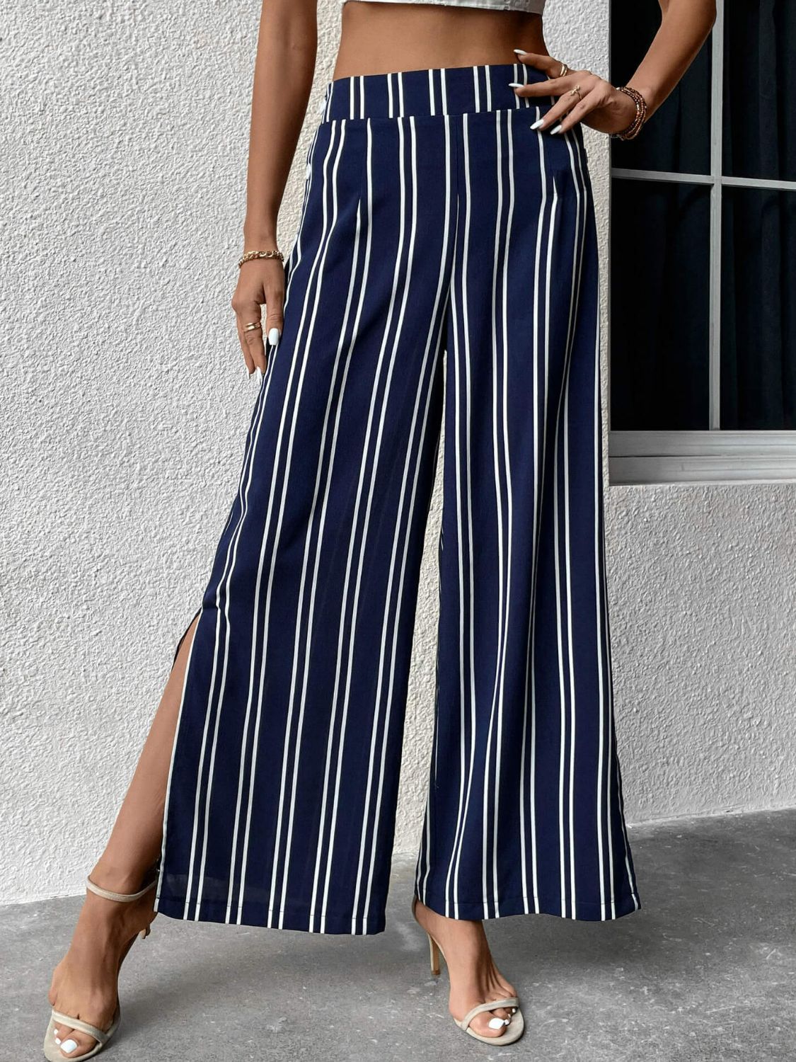 Striped slit wide leg pants with decorative buttons, casual minimalist style.