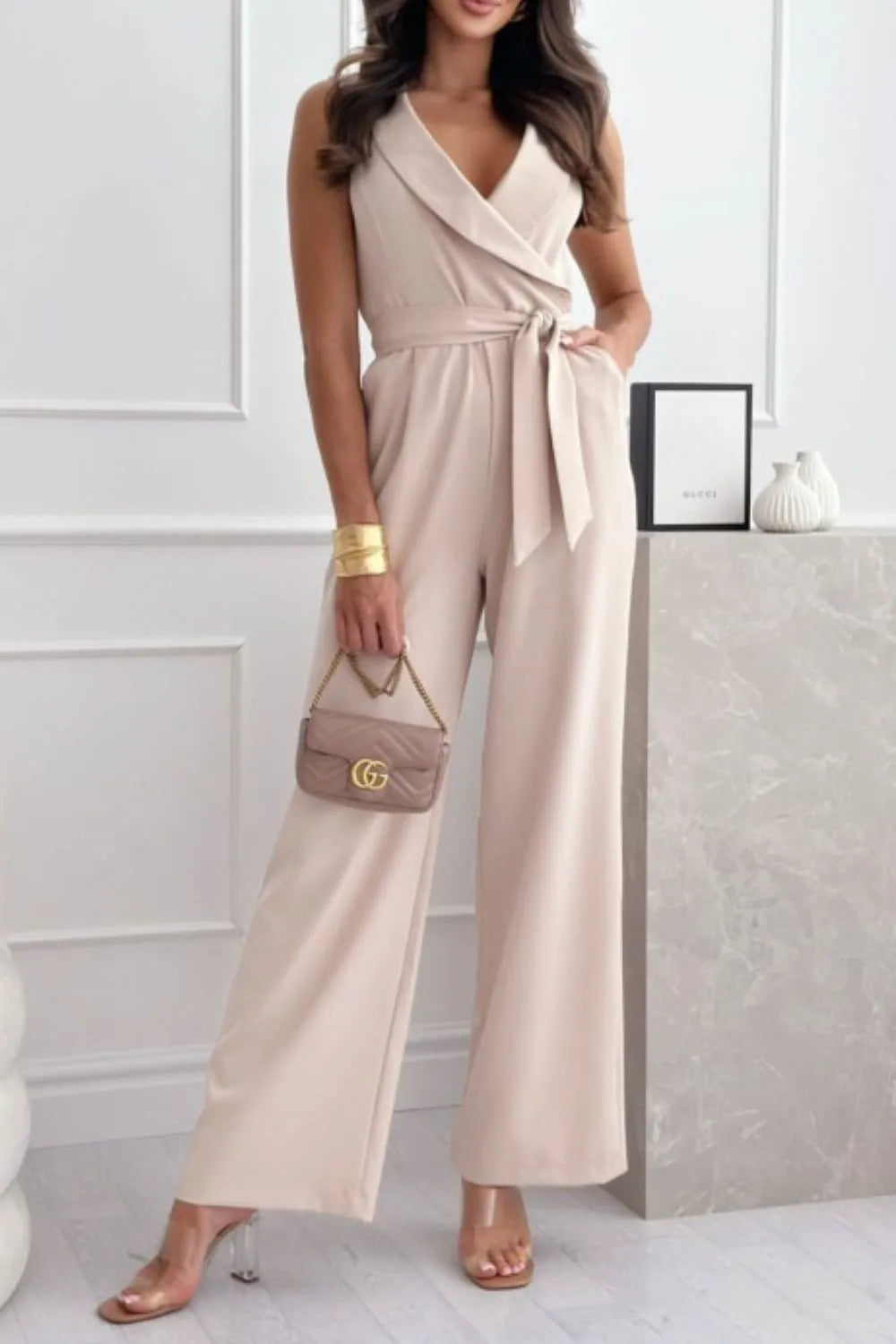 Surplice Sleeveless Wide Leg Jumpsuit with Tie and Pockets.