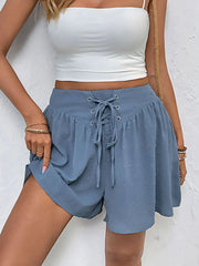 High-waist V-front Bermuda denim shorts with pockets.