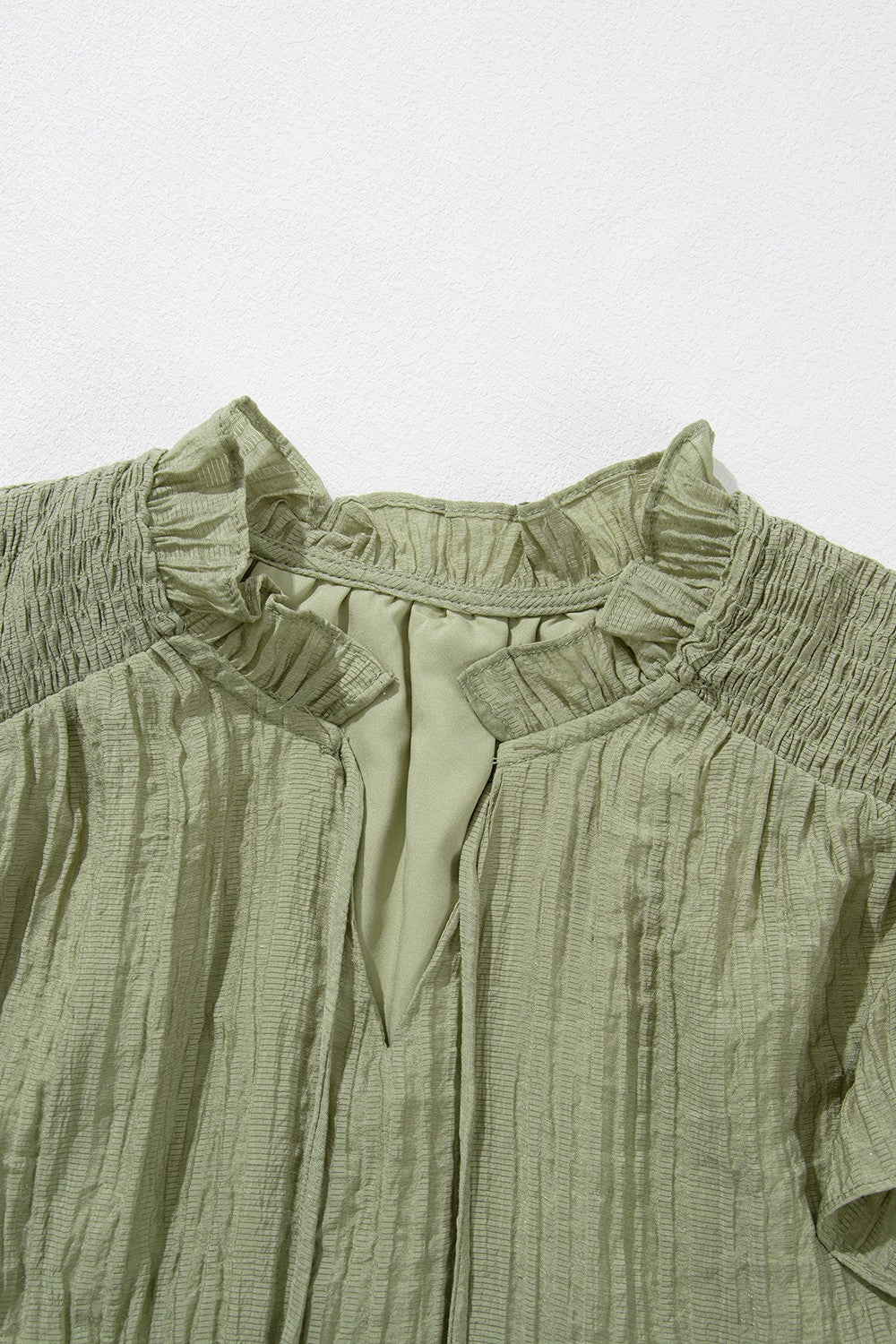 Tassel Tie Neck Flutter Sleeve Textured Blouse.