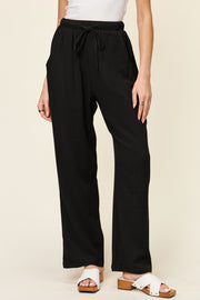 Texture drawstring straight pants with pockets, opaque.